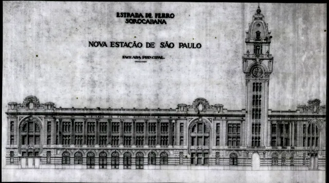 A imagem mostra o desenho do novo projeto da Estação Júlio Prestes, um prédio imponente, com muitos detalhes arquitetônicos, janelas, arabescos e uma grande torre de relógio. 